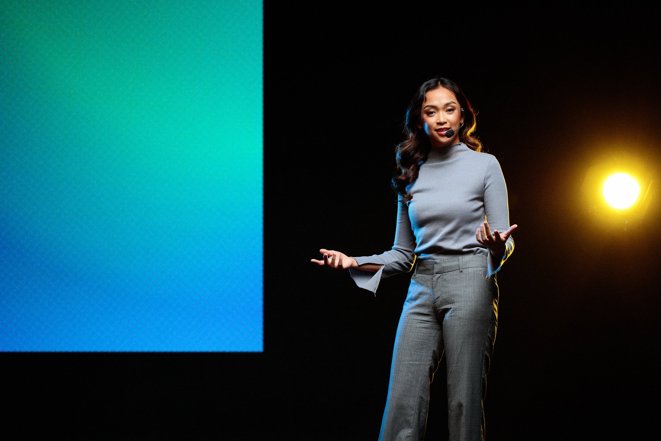 Woman Giving a Talk in Public on Stage